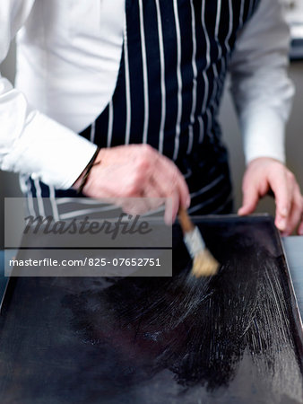 Buttering the baking tray Buttering the baking tray