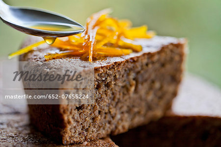 Coating a slice of hazelnut cake with orange juice Coating a slice of hazelnut cake with orange juice