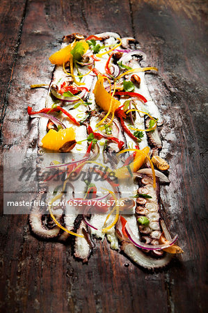 Giant octopus ceviche with orange and peppers