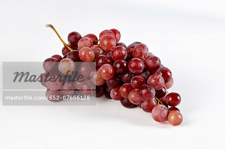 Bunch of red grapes on a white background