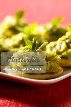 Blinis topped with minty cilantro zucchini puree