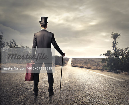 Gentleman standing on a long road