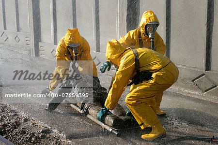 Man in chemical protection suit, carrying out the decontamination area