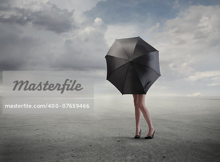 Girl in a wasteland protecting with an umbrella
