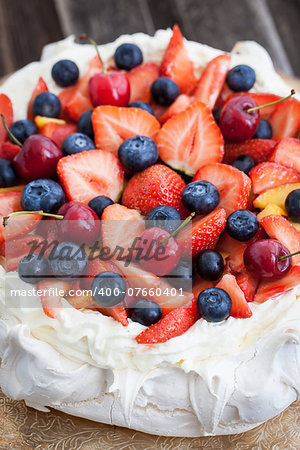 Pavlova meringue cake decorated with fresh berries