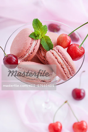 Pink french macarons with fresh cherry and mint