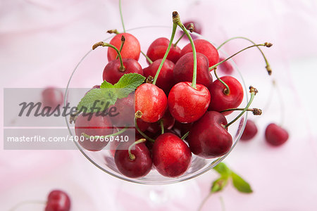 Fresh wet cherry in a glass, close up