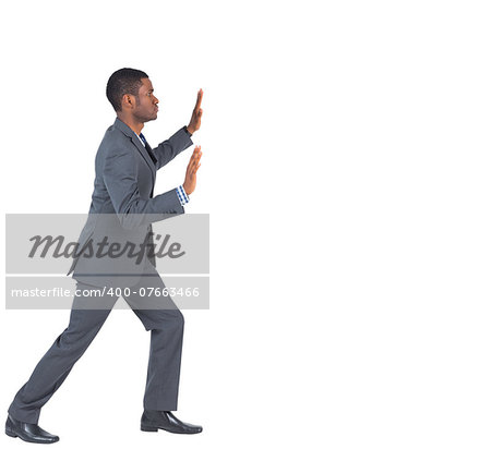 Businessman standing and pushing with hands on white background