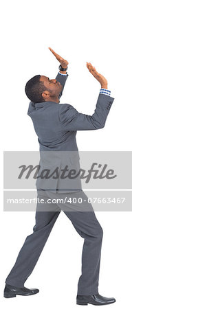 Businessman standing and pushing up on white background