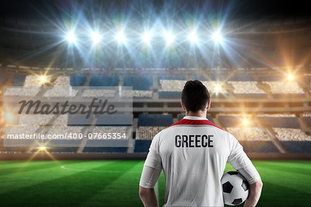 Greece football player holding ball against stadium full of greece football fans