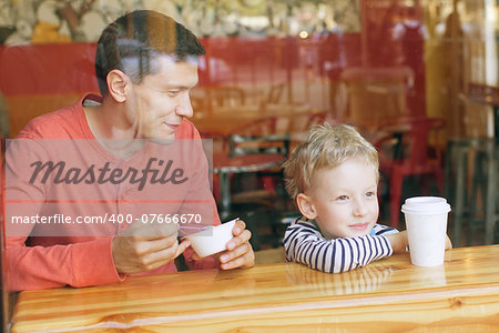 family of two enjoying time together in cafe