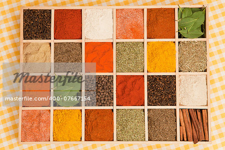 Spices collection. Various dry spices in wooden box.