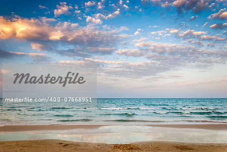 Tropical Beach and Beautiful Sea at Cloudy Sunset