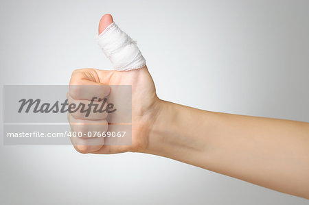 Injured painful finger with white bandage