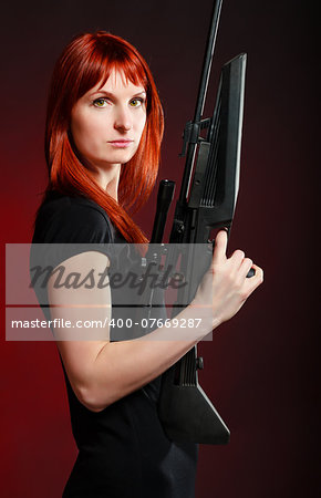 woman in black dress with sniper rifle, red background