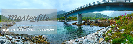 Norwegian Sea cloudy night view with stony coast and bridge (not far Vagan, Norway).