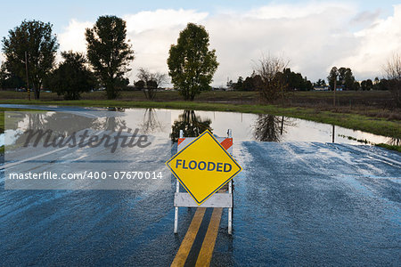 Flooded warning sign on an impassable road, San Martin, California