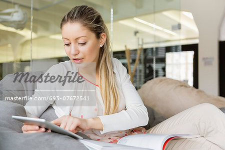 Young businesswoman using tablet PC in office