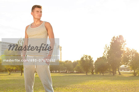 Confident jogger standing in park