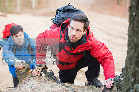 Young backpackers hiking in forest