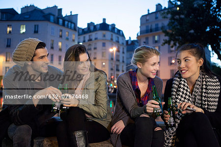 Friends having beer together outdoors