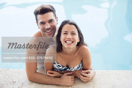 Young couple in pool together, portrait
