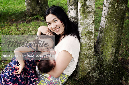 Mother with baby and little girl outdoors