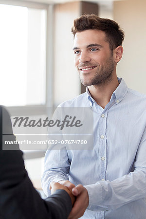 Client shaking hands with businessman