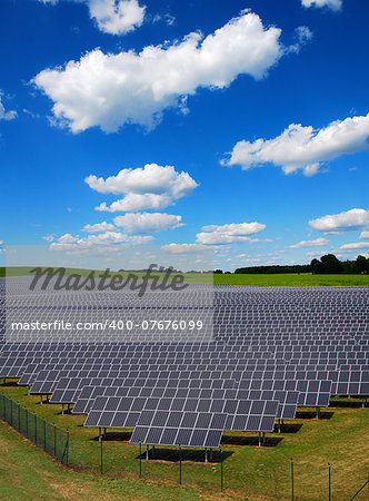 solar power station under blue sky, panels producing electricity