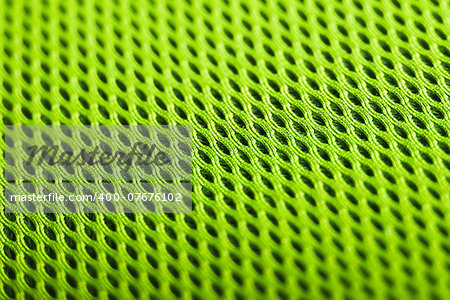 green background. Mesh fabric texture. Macro perspective