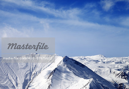 Snowy mountains at sunny day. Caucasus Mountains, Georgia, view from ski resort Gudauri.
