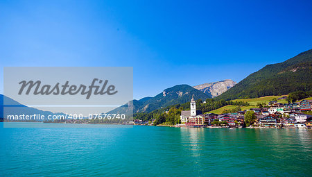 View of View of St. Wolfgang chapel and the village waterfront at Wolfgangsee lake, Austria