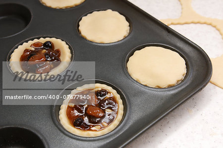 Mince pies being made - open and finished with plain pastry lids