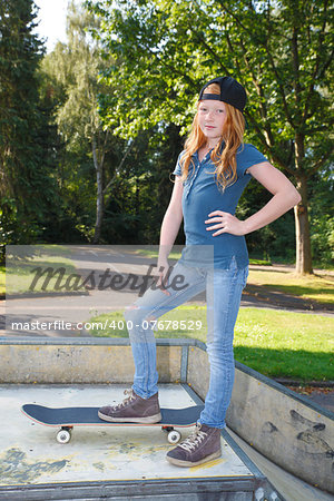 Cool young girl outdoor with skateboard