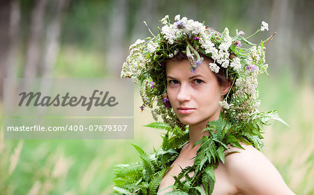 portrait of a young woman wearing a crown of summer wildflowers