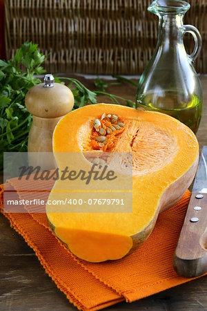 fresh raw pumpkin sliced on a wooden table