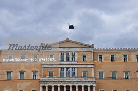 Hellenic parliament neoclassical building facade under cloudy sky. Athens, Greece.