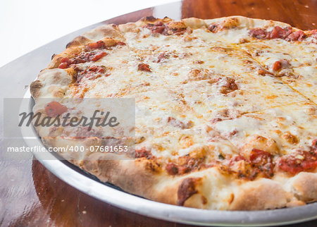 Fresh and hot cheese pizza served on wooden table, stock photo