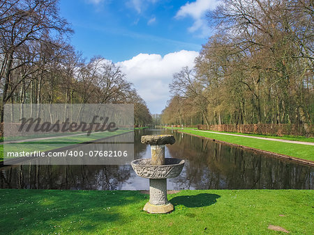 Stone fountain by the beautiful pond in the park of Kasteel De Haar