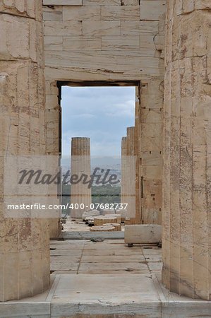 View to the city of Athens Greece from the Acropolis Propylaia. Ancient columns and gate.