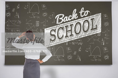 Composite image of businesswoman scratching her head against black chalkboard