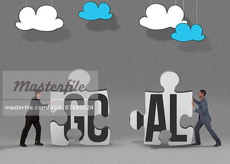 The word goal and businessman standing and pushing against grey jigsaw pieces