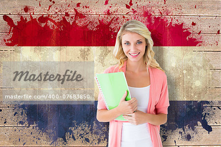 Young pretty student smiling against netherlands flag in grunge effect