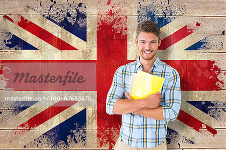 Young student smiling  against union jack flag in grunge effect