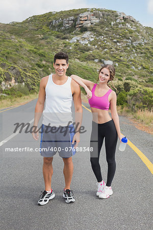 Portrait of a fit young couple standing on the open road together