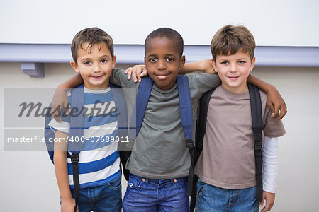 Classmates smiling at camera in classroom at the elementary school