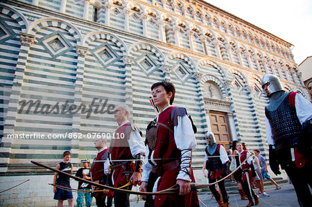 Italy, Tuscany , Pistoia. Performers with bow and arrow during the annual parade for the feast of San Jacopo.
