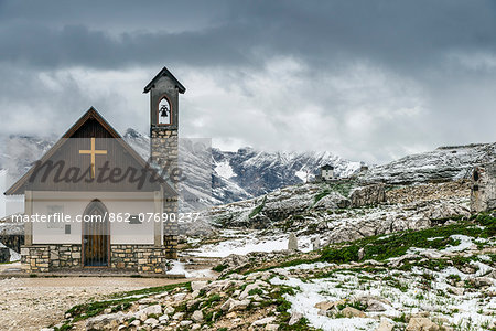 Small mountain church in the Dolomites after a summer snowfall, Cadore, Veneto, Italy