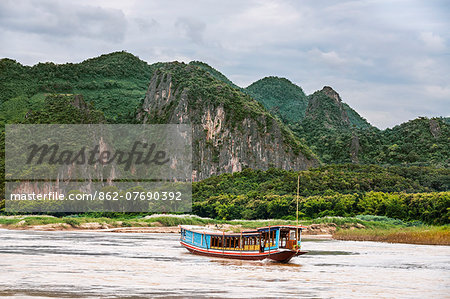 Laos, Luang Prabang, Luang Prabang Province. A tourist riverboat on the Mekong River near Luang Prabang.