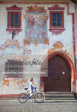 Woman walking past decorative building in Radnicne Square, Bardejov (UNESCO World Heritage Site), Presov Region, Slovakia